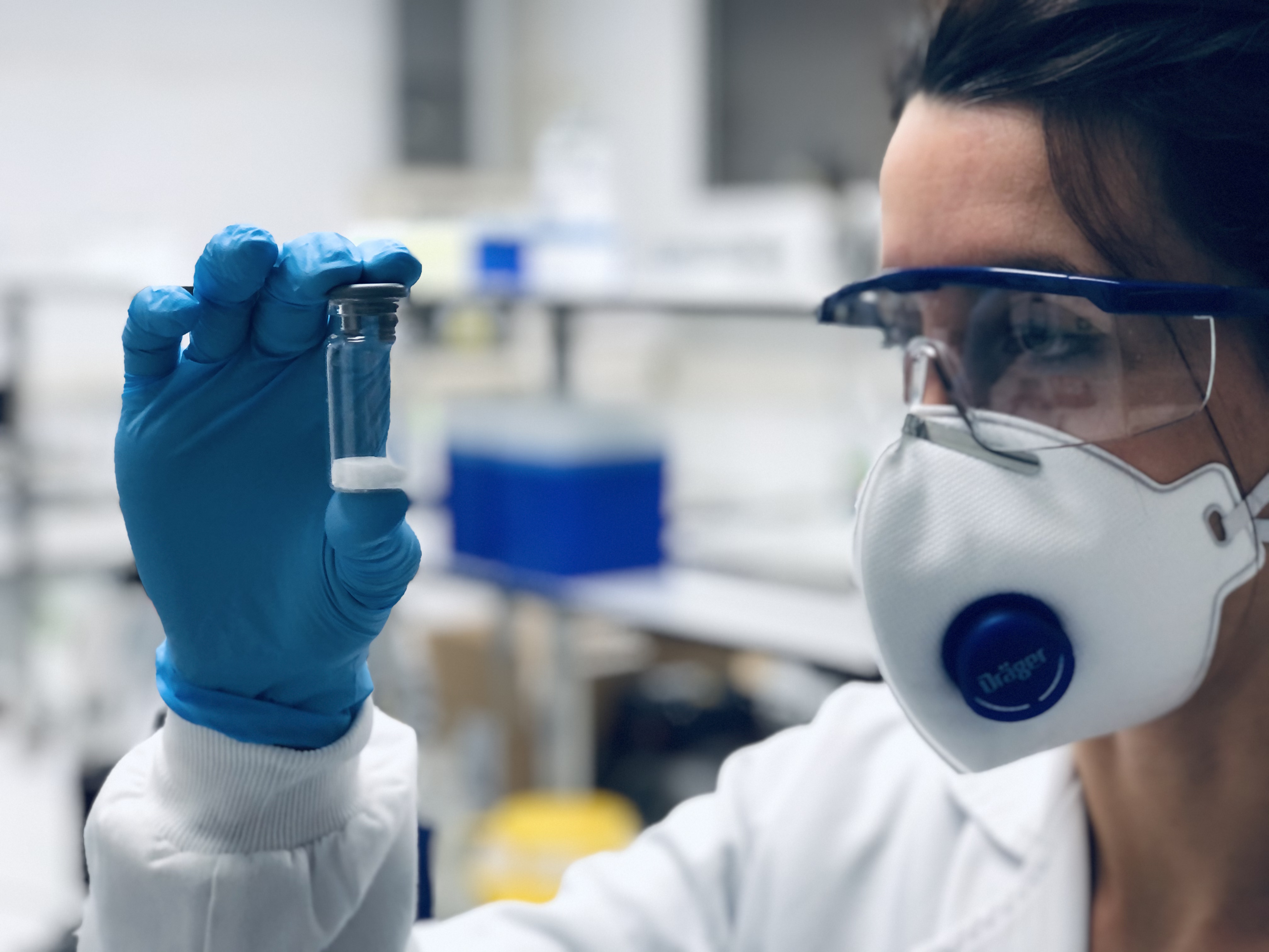 Maria Aguilar during a visual inspection of a vial. Maria is the R&D Laboratory Manager.